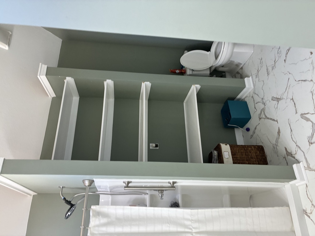 Renovated interior with tile and built-in shelving by Top Rock Solutions
